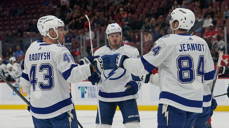 Tampa Bay Lightning left wing Tanner Jeannot (84) is congratulated by teammates for his goal...