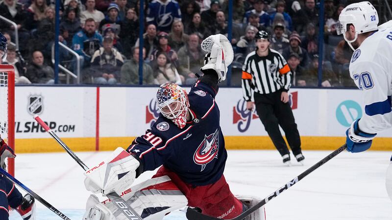Columbus Blue Jackets goaltender Elvis Merzlikins (90) blocks a shot by Tampa Bay Lightning...