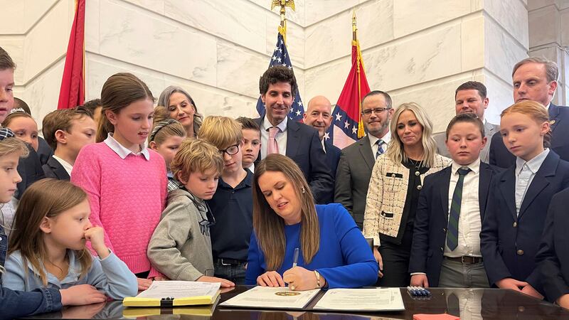FILE - Arkansas Gov. Sarah Huckabee Sanders signs into law an education overhaul bill on...