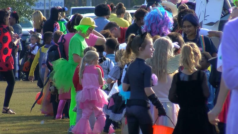 Ocean Springs High students handed out candy to hundreds of elementary students at the...