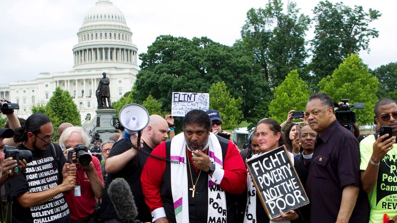 FILE - In this Saturday, June 23, 2018 file photo, Rev. Dr William Barber II accompanied by...