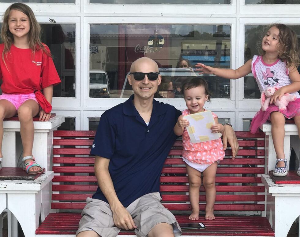 Sean Delcambre poses with his daughters Lillianne, left, Lucia, center, and Ellie on July 19,...