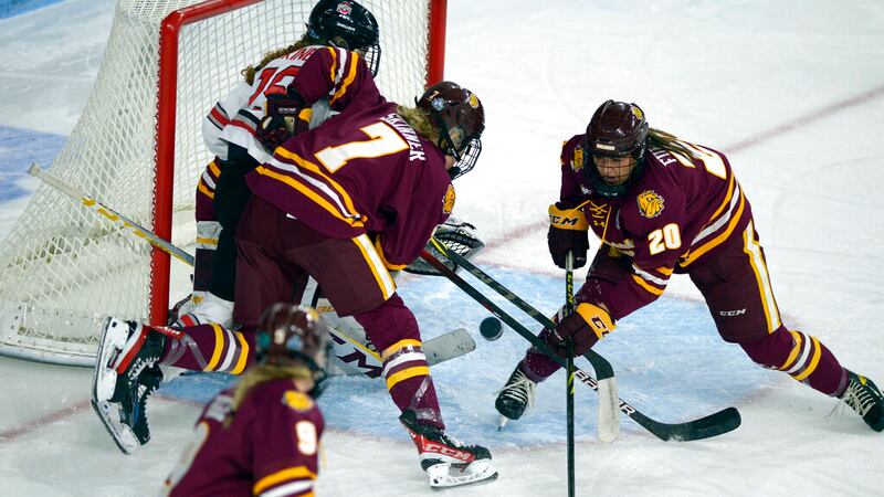 Ohio State's Sara Saekkinen, top left, is cleared away from the net by Minnesota-Duluth's...
