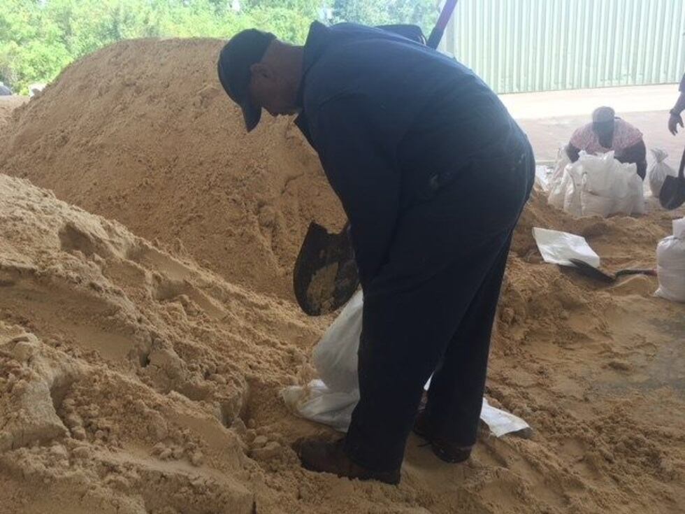 A Jackson County resident shovels sand into a bag ahead of Gordon (photo source: WLOX)