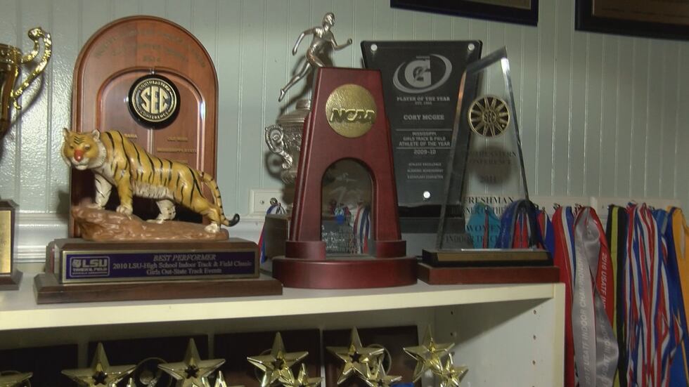 The walls of Cory's bedroom are covered in awards, in addition to shelves of trophies and medals.