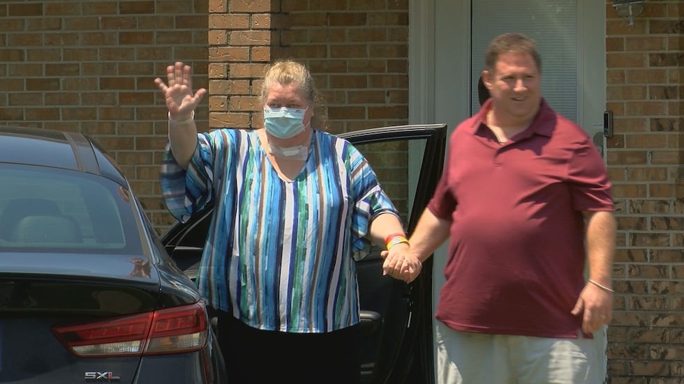 Jolene and Patrick Rosado waive to friends that are welcoming Jolene home.